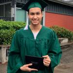A graduate from Truman Campus Career Academy holds his diploma at the graduate walk recordings. Courtesy photo