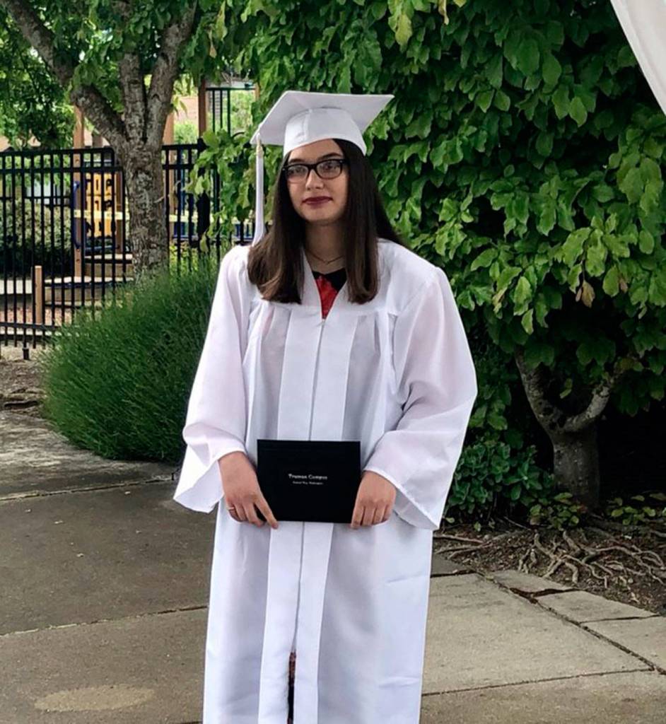 A graduate from Truman Campus Internet Academy holds her diploma at the graduate walk recordings. Courtesy photo