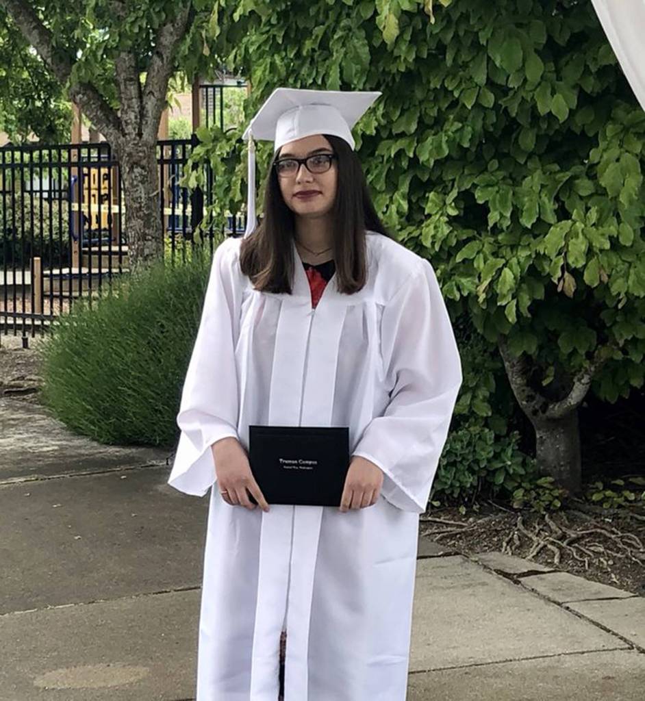 Andrea Rivera from Truman Campus Open Doors holds her diploma at the graduate walk recordings. Courtesy photo