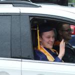 A Decatur senior waves to soon-to-be former teachers on Friday, June 12.