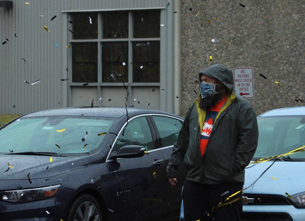 A Decatur staff member reacts as a member of a graduates family releases a confetti cannon on June 12.