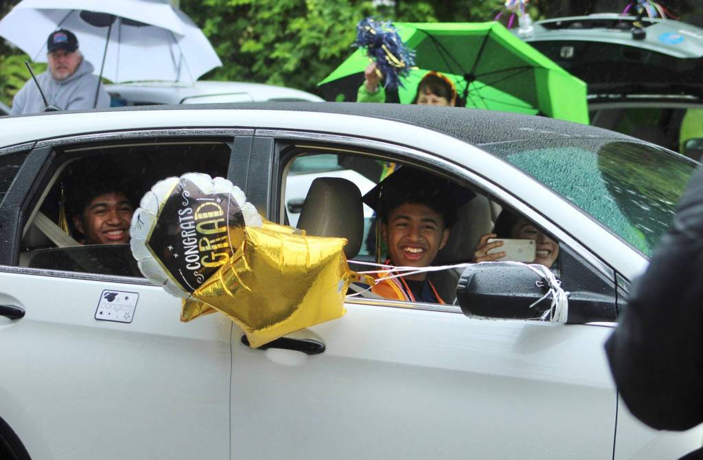 Two Decatur seniors smile as they exit the parade route on June 12.