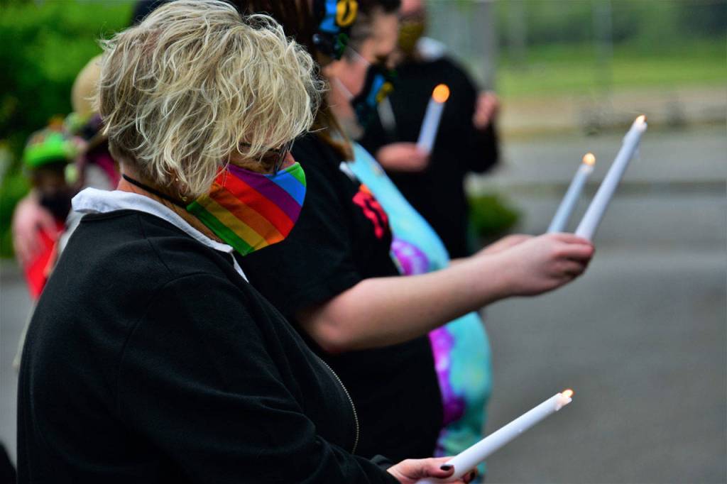 Sen. Claire Wilson holds a candle during the June 26 ceremony. Photo courtesy of Bruce Honda