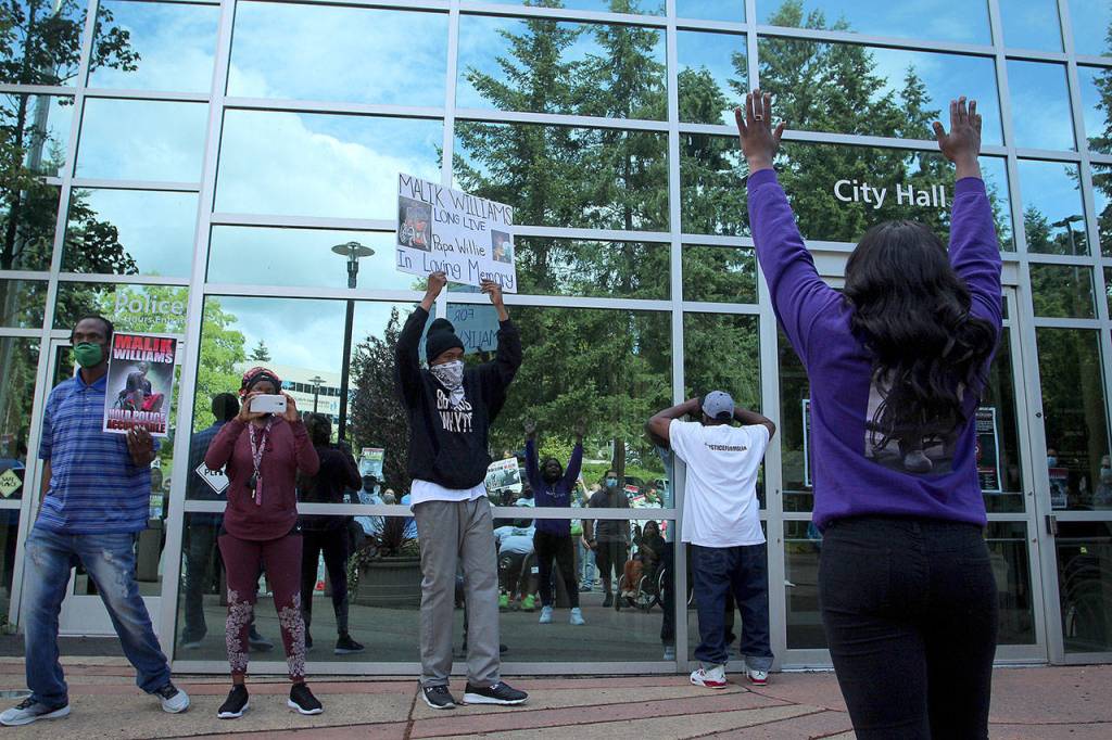 Monique Phelps raises her hands and chants hands up, dont shoot at Federal Way City Hall on June 28. Olivia Sullivan/staff photo