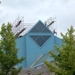 Two people work on the roof of the Weyerhaeuser King County Aquatic Center on July 22. Olivia Sullivan/staff photo