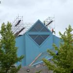 Two people work on the roof of the Weyerhaeuser King County Aquatic Center on July 22. Olivia Sullivan/staff photo