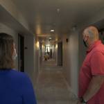FUSION Executive Director Robin OGrady, left, and Project Manager David Harrison peer down a hallway under renovation of the new FUSION emergency family shelter in Federal Way. Olivia Sullivan/staff photo
