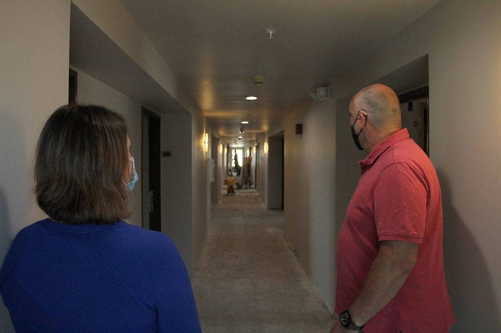 FUSION Executive Director Robin OGrady, left, and Project Manager David Harrison peer down a hallway under renovation of the new FUSION emergency family shelter in Federal Way. Olivia Sullivan/staff photo