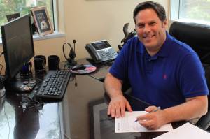 Federal Way Mayor Jim Ferrell signs contracts to recipients of the first round of the CARES Acts grants. Photo courtesy of City of Federal Way