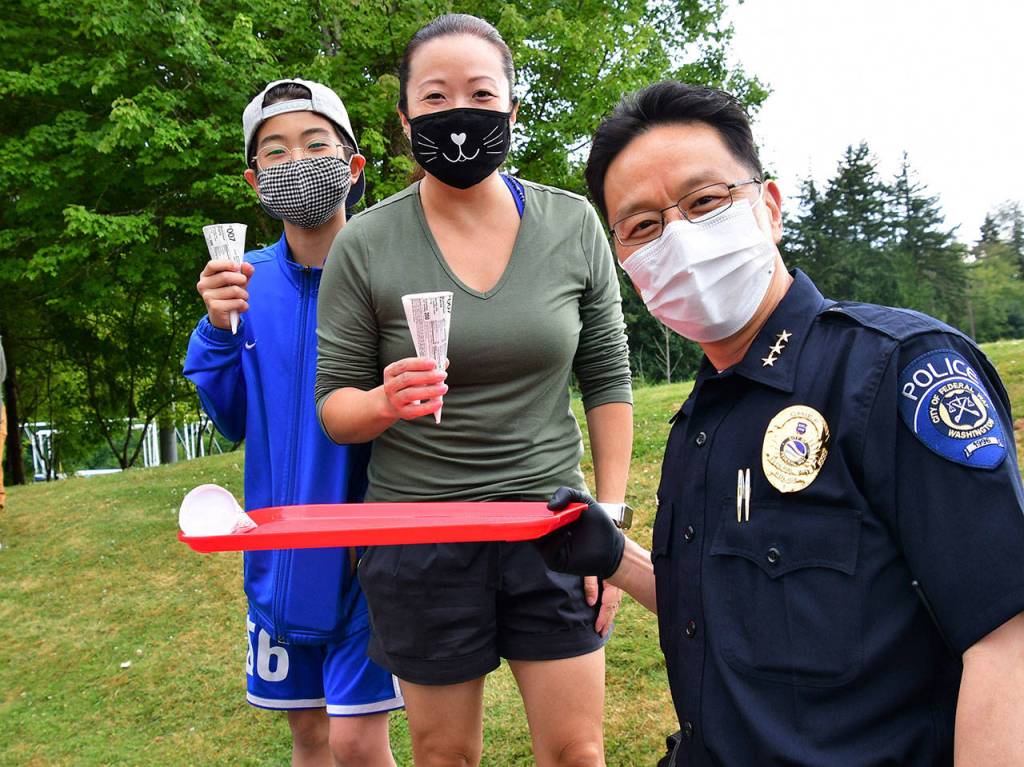 Federal Way Police Chief Andy Hwang hands out ice cream to local residents on Aug. 6. Photo courtesy of Bruce Honda