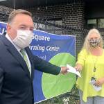 Todd Keeney, president of the Federal Way Washington Stake of the Church of Jesus Christ of Latter-day Saints, presents a check towards diapers for FWPS families to Laura Batcheller, ECEAP/Head Start (ESTART) program manager​ of Federal Way Public Schools. Courtesy photo