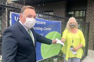 Todd Keeney, president of the Federal Way Washington Stake of the Church of Jesus Christ of Latter-day Saints, presents a check towards diapers for FWPS families to Laura Batcheller, ECEAP/Head Start (ESTART) program manager​ of Federal Way Public Schools. Courtesy photo