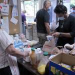 Volunteers helps package meals and hand out beverages on Aug. 27 at Calvary Lutheran Church in Federal Way. Olivia Sullivan/staff photo