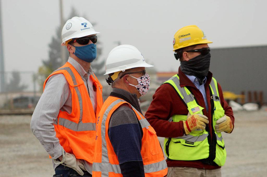 Construction Manager Nathan Monroe, left, watches drill shaft installation at the Sound Transit Kent/Des Moines site on Oct. 7. Olivia Sullivan/the Mirror