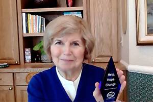 Jeanne Burbidge poses with her Help, Hope, Change award. Courtesy photo