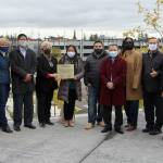 Sen. Claire Wilson, members of Federal Way City Council, King County Council member Pete von Reichbauer, and other local leaders pose for a photo with the dedicated time capsule plaque. Olivia Sullivan/the Mirror