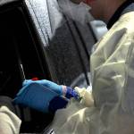 Firefighter Blake Gillespie of South King Fire holds a swab before administering a COVID-19 test on Nov. 18. Olivia Sullivan/the Mirror