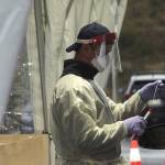 A South King Fire & Rescue firefighter places a used test swab into a secure vial on Nov. 18. The tests are transported from Federal Way to a Seattle lab for processing twice a day. Olivia Sullivan/the Mirror