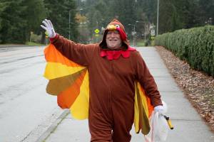 Tom Sites, 74, waves to a passing car while on his usual litter-picking route along SW 320th Street in Federal Way on Nov. 23. Olivia Sullivan/the Mirror