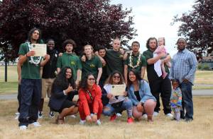 Olivia Sullivan/staff photo
Graduates of the Credible Messenger Green Hill School pilot program, in green polos, proudly celebrate with the programs mentors after the ceremony on Friday, June 21, 2019. Progress Pushers Founder Eddie Purpose is pictured second from left.