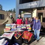 Co-leaders Betty Clifford, far right, and Marjorie Simpson, second from right, meet with Roger Flygare, Capt. Brad Chaney and Hanna Bailey of Quixote Communities on Dec. 1 to donate handmade items to organizations serving the local area. Photo courtesy of Terry Johnson of St. Luke's Lutheran Church