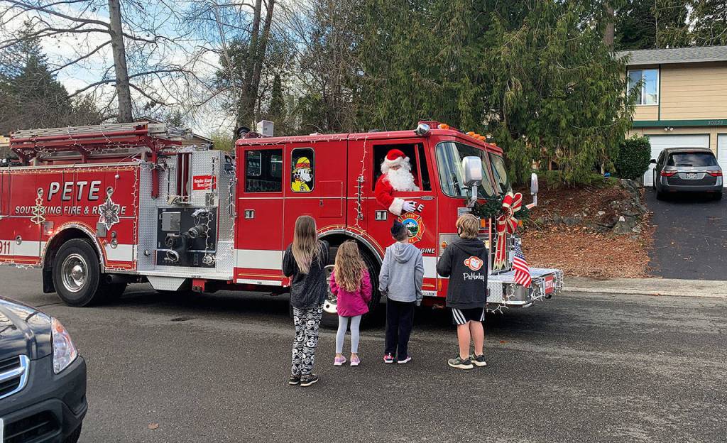 Local kids greet Santa Claus aboard South King Fires PETE engine. Photo courtesy of SKFR