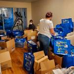 Volunteers help pack dozens of swag bags to be handed out Saturday, Dec. 19. Photo courtesy of Eddie Purpose