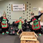 Volunteers pose for a photo next to dozens of bagged toys ready to be gifted to local families. Photo courtesy of Gina Duckett