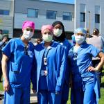 St. Francis Hospital employees pose for a photo, before laughing about smiling behind their masks. A parade to show support to frontline hospital workers took place in April. Olivia Sullivan/staff photo