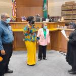 State Rep. Jamila Taylor is sworn in by Superior Court Judge Nicole Phelps with her parents, Dr. Quintard Taylor, left, and Carolyn F. Taylor on Jan. 10. Courtesy photo