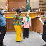 State Rep. Jamila Taylor is sworn in by Superior Court Judge Nicole Phelps with her parents, Dr. Quintard Taylor, left, and Carolyn F. Taylor on Jan. 10. Courtesy photo