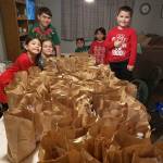 Cousins of the Jones family prep food packages in Dec. 2020. Courtesy photo