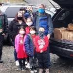 Larry Jones, right, stands with his family while donating food packages in Dec. 2020. Courtesy photo