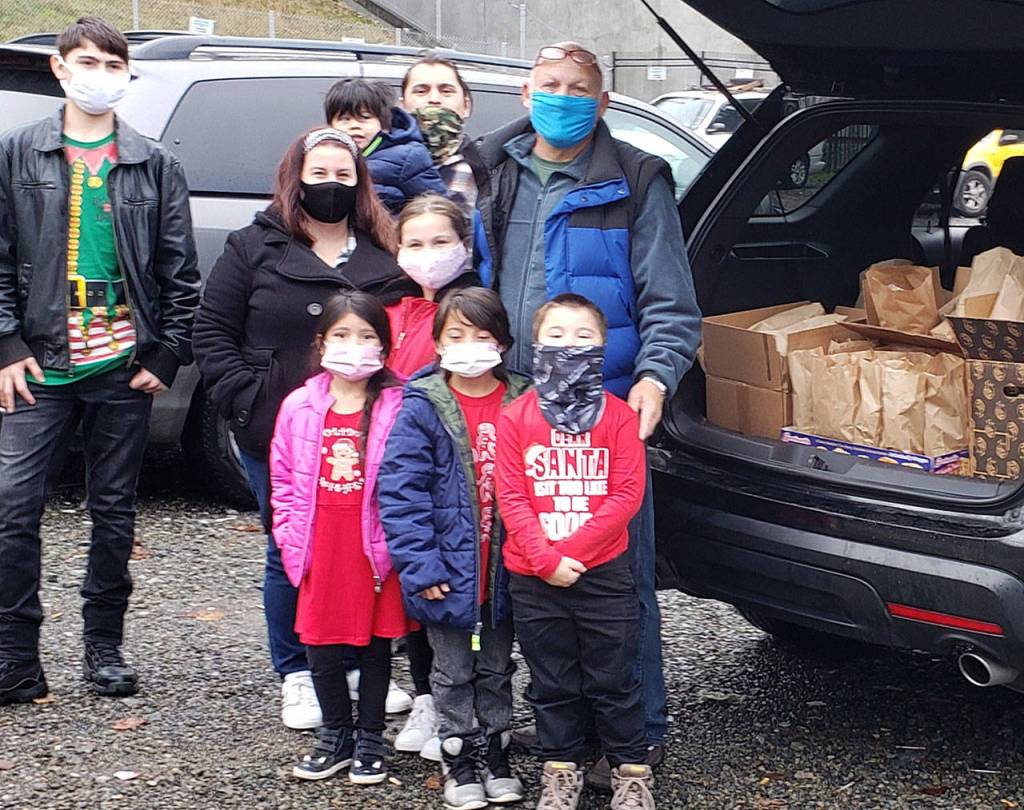 Larry Jones, right, stands with his family while donating food packages in Dec. 2020. Courtesy photo