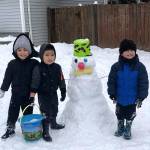 Darius, 5, Kayden, 3, and Toamalama, 3, enjoy the snow day with their snowman. Photo courtesy of Frances S. Papatu