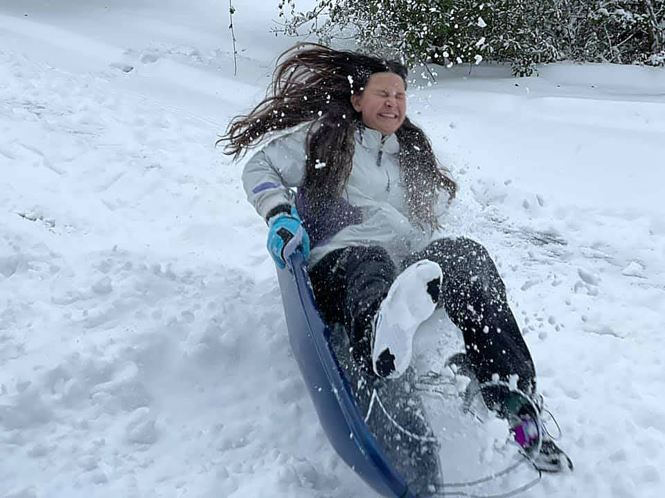 Amisyn Zancanella hits a rough landing while sledding in Federal Way.Photo courtesy of Amanda Zancanella Judd