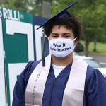 Senior Tayshon Cottrell dons his graduation cap and gown, along with a face mask reading: “Wear it! Save America” at Todd Beamer High School’s virtual graduation walk recording on May 20, 2020, in Federal Way. Olivia Sullivan/the Mirror
