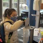 A student at Panther Lake Elementary gets her temperature checked before the start of the in-person school session on March 15. Olivia Sullivan/the Mirror