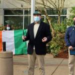 L-R: Audrey Patrick and Anna Patrick hold the Irish flag as Craig Patrick speaks to the crowd after Mayor Jim Ferrell on March 17. Olivia Sullivan/the Mirror