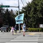 Ted Colby Sanchez carries a March of Diapers flag while running in Federal Way on April 11.