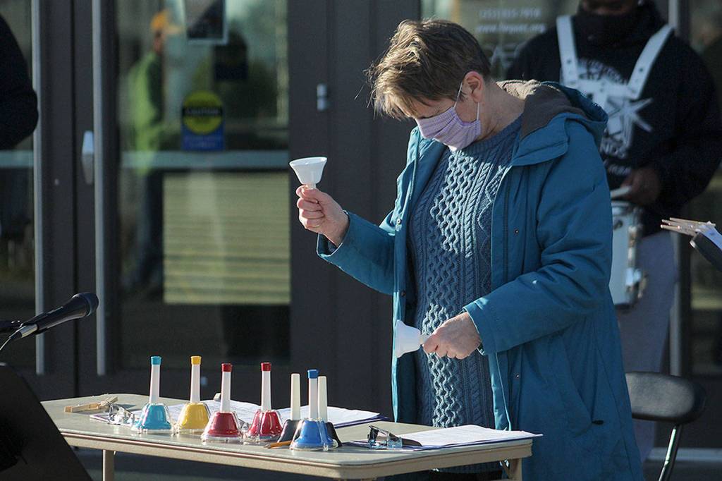 Jan Barber, project manager of Make Music Federal Way, rings bells on Jan. 18 in honor of the more than 400,000 people who have died from COVID-19. Olivia Sullivan/The Mirror