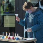 Jan Barber, project manager of Make Music Federal Way, rings bells on Jan. 18 in honor of the more than 400,000 people who have died from COVID-19. Olivia Sullivan/The Mirror