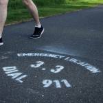 Olivia Sullivan/the Mirror
A man walks past an emergency location mile marker along the BPA Trail at dusk on May 11.
