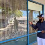 Kabal Gill stands in front of a shattered window of his restaurant East India Grill in Federal Way on May 14. Olivia Sullivan/the Mirror