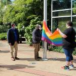 State Sen. Claire Wilson (far left) and Federal Way Mayor Jim Ferrell watch as Allison Taylor holds part of the pride flag as it is raised on a flagpole outside of City Hall on Monday, June 1, 2020. Olivia Sullivan/staff photo