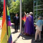 Resident Serena Starr, middle, helps raise the pride flag in Federal Way on June 1. Olivia Sullivan/the Mirror