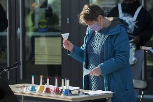 Jan Barber, project manager of Make Music Federal Way, rings bells on Jan. 18 in honor of the more than 400,000 people who have died from COVID-19. Olivia Sullivan/The Mirror