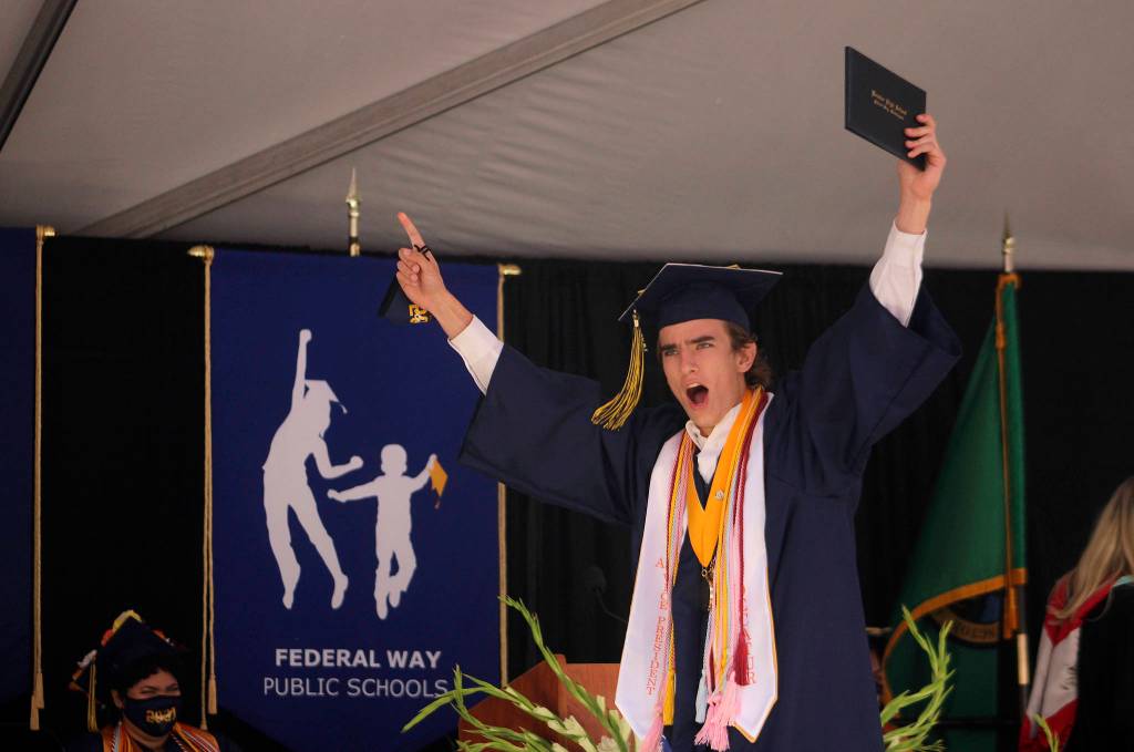 Decatur graduate William Forbes, class valedictorian and ASB vice president, cheers in triumph after picking up his diploma on June 12. Olivia Sullivan/the Mirror