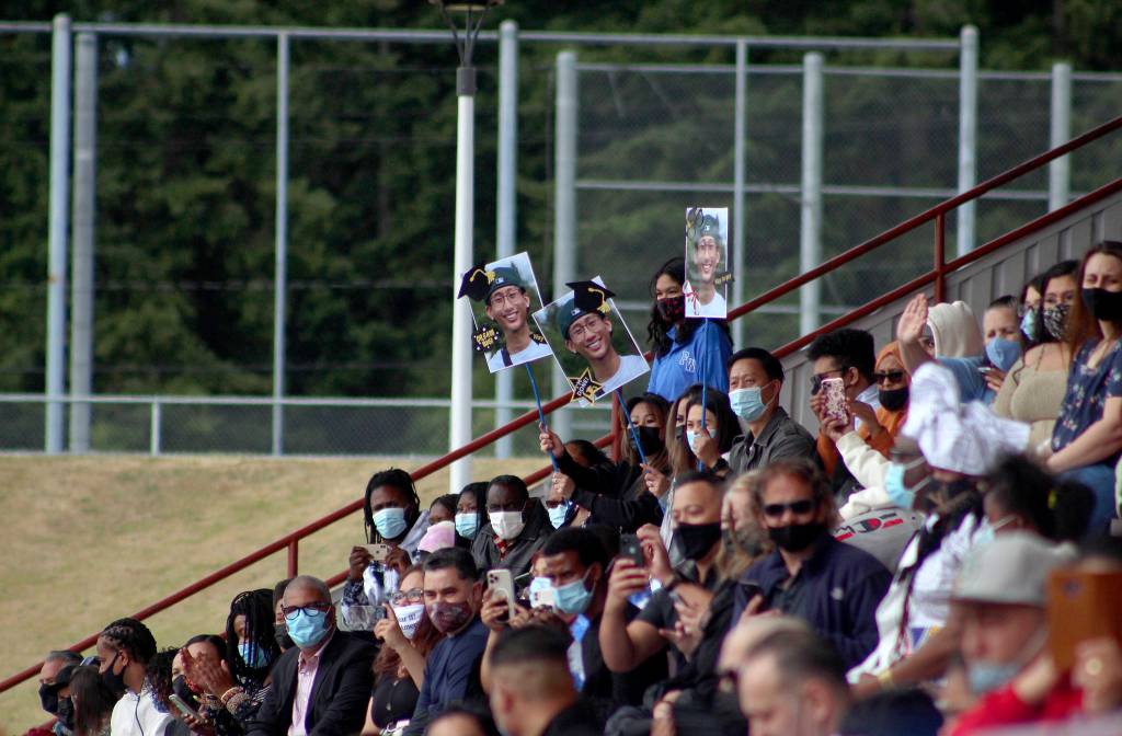 A family holds signs in support of their graduate on June 12. Olivia Sullivan/the Mirror
