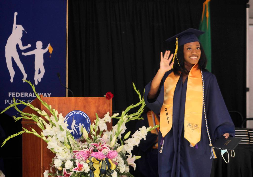 A Decatur graduate waves to her family in the crowd on June 12. Olivia Sullivan/the Mirror